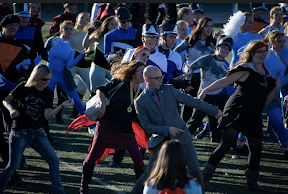 Band directors (Dylan Ford, middle) dancing with other marching band students in one final reunion at TrailBlazer Stadium on Saturday afternoon.