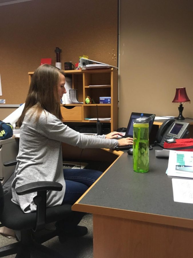 Amy Doolittle takes care of business, such as scheduling student conferences and answering questions from concerned parents, in her office.