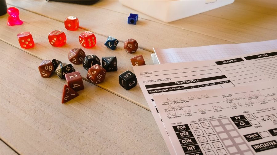 D&D players create characters by rolling dice and choosing attributes through the Player’s Handbook. The Game Master, most commonly called the Dungeon Master, writes the story these characters will interact with. 
Photo credit: Pexels