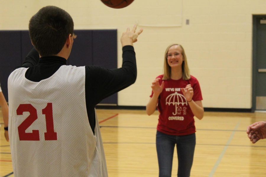 Sophomore Kenna Anderson passes the ball to another Unified player.