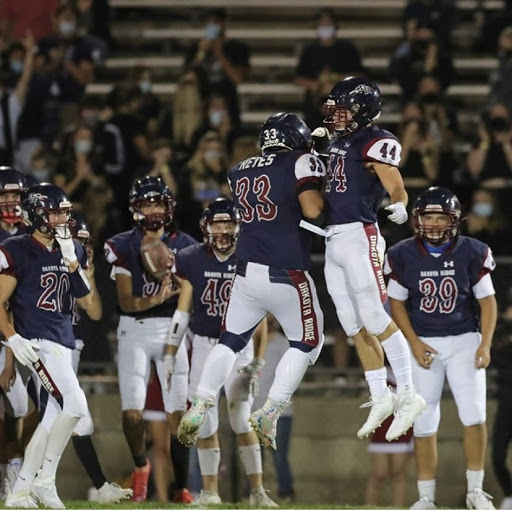 Steve Reyes(12) and Charlie Offerdahl (12) celebrate after another touchdown by Offerdahl.