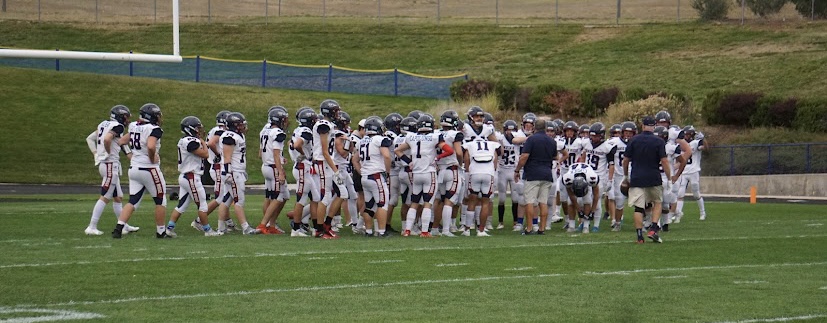 Dakota Ridge football team has a pre game huddle.