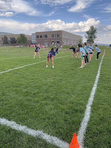 Two competitive powderpuff teams get ready to go through their plays.  The softball team won.
