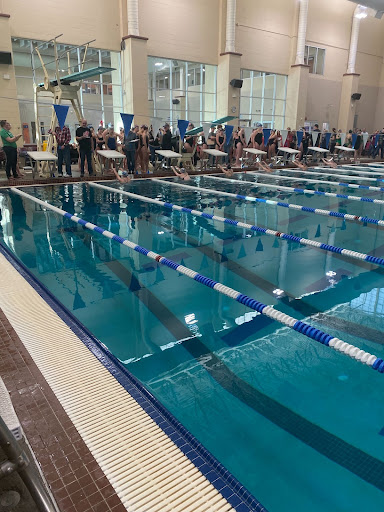 Swimmers preparing to begin a 400 relay race.