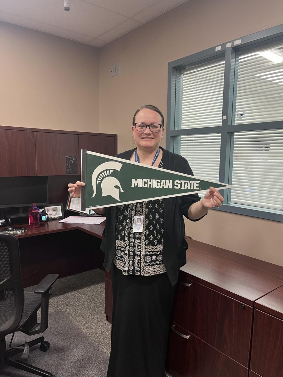 Jennifer Kelley proudly displays her Michigan State flag. She majored in English with a minor in psychology. Michigan is also where she received her teaching certification. 