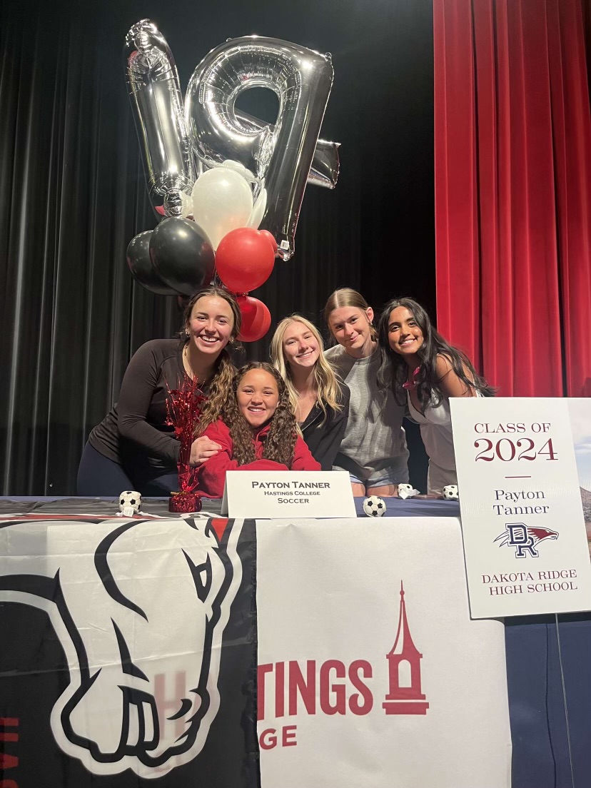 Payton Tanner (seated) will carry on the womens soccer state title to Hastings College. Hard work and long hours paid off for her playing more professionally.

“Grades mattered a lot,” senior Payton Tanner said. I have half of my money because of grades, and the other half for sports. So they made a big difference and impact on the scholarship I got.“ 

