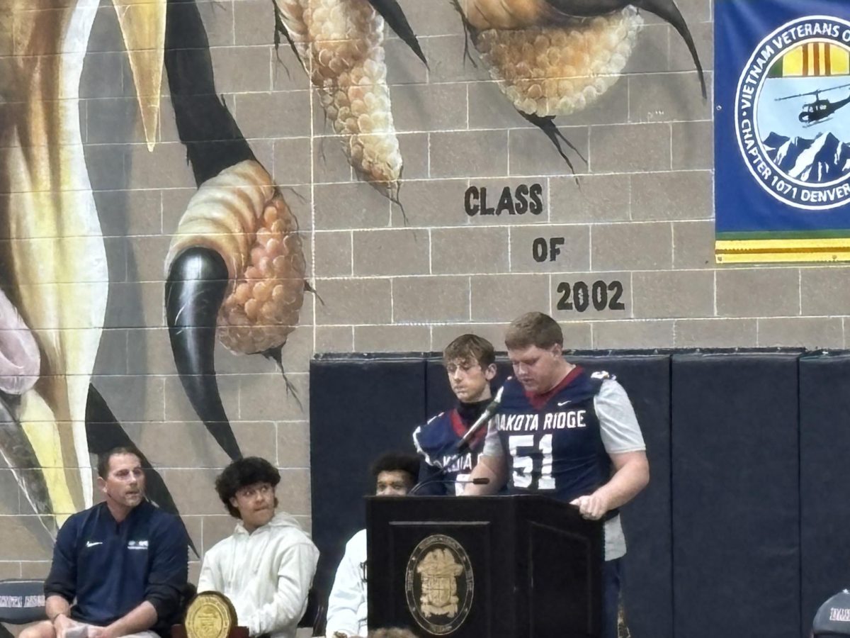 The Dakota Ridge Eagles football team wins the state championship this year, with a perfect season officially behind them. On Wednesday, December 10, 2025, the school held an assembly to honor the football team and their coach, Coach Behrendsen. “When we were backed against a wall,” said the coach in his speech, “the people on this floor and the people in this room held the rope.”